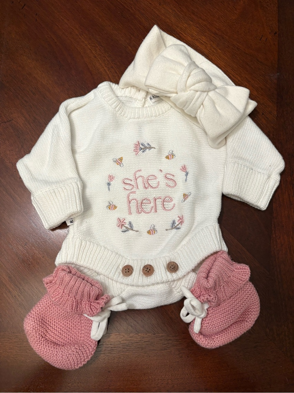 Raising Reign Cream Knit Baby One-Piece Bodysuit with Pink Accents - She's Here